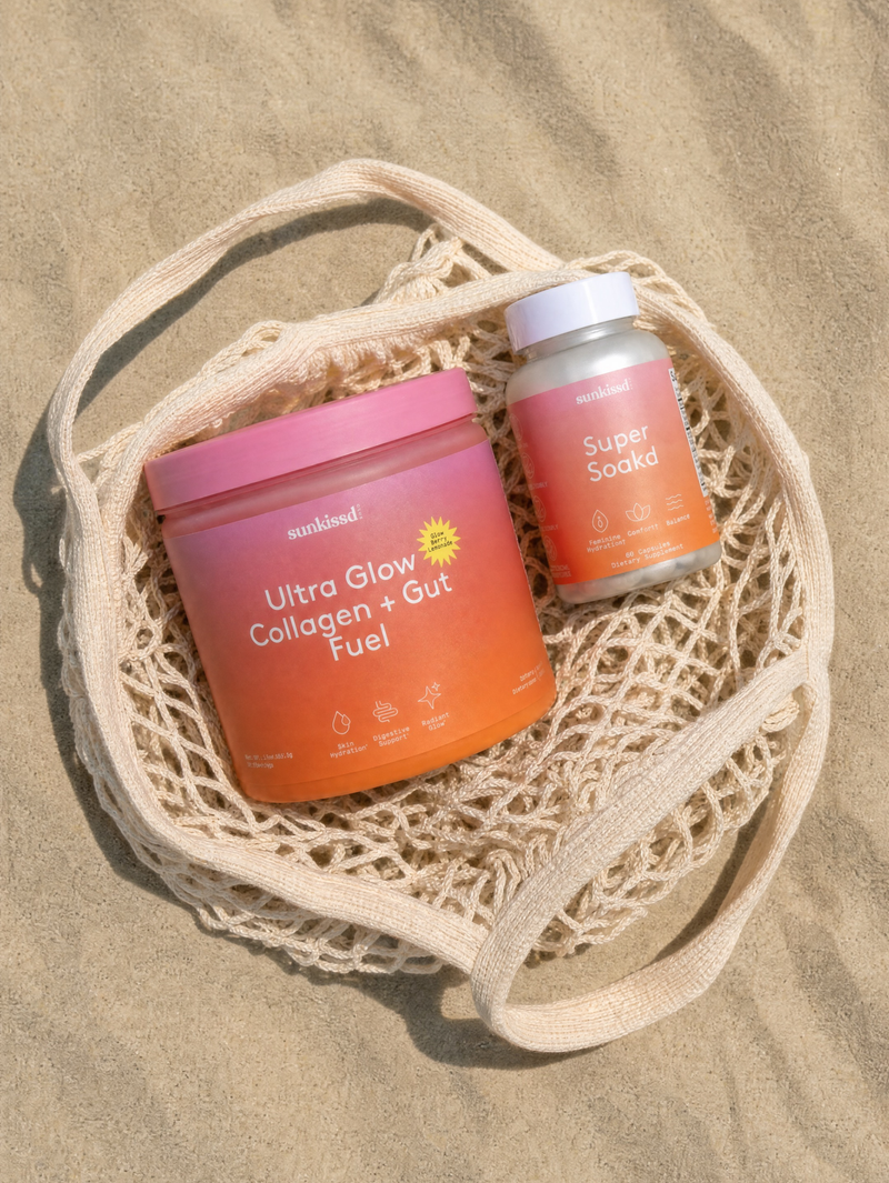 Two sunkissd club supplement containers placed on a beige mesh tote bag over sand: a large pink-to-orange gradient jar labeled Ultra Glow Collagen + Gut Fuel, and a smaller matching bottle labeled Super Soakd.