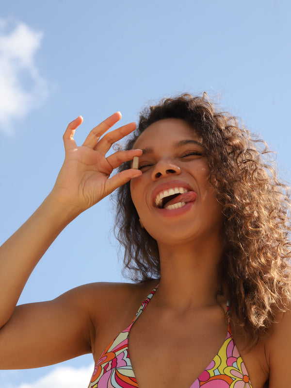 Woman in a colorful swimsuit against a blue sky
