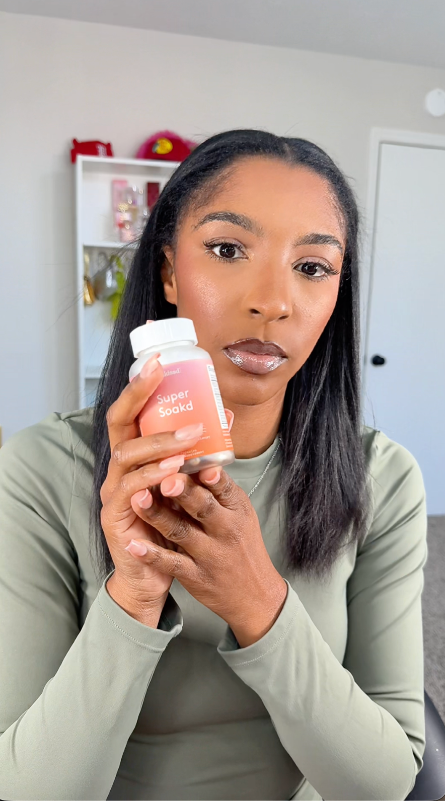 Woman holding a supplement bottle in a casual setting