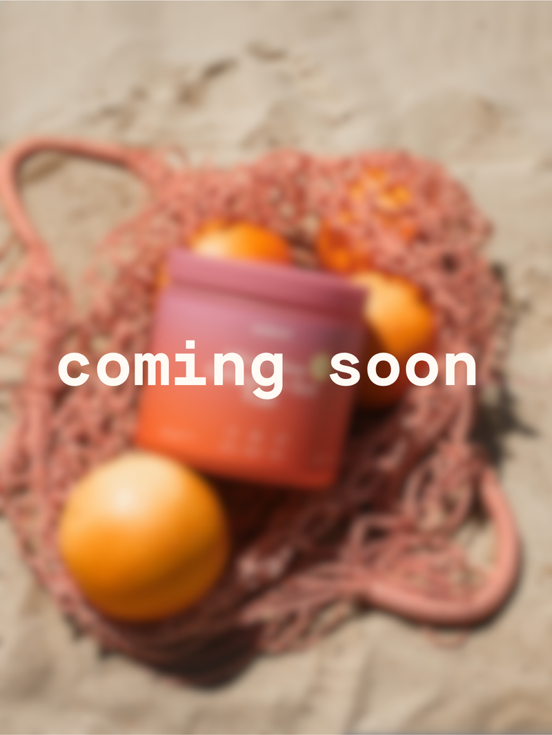 Mesh bag with oranges and a pink container on a textured surface, with 'coming soon' text overlay.